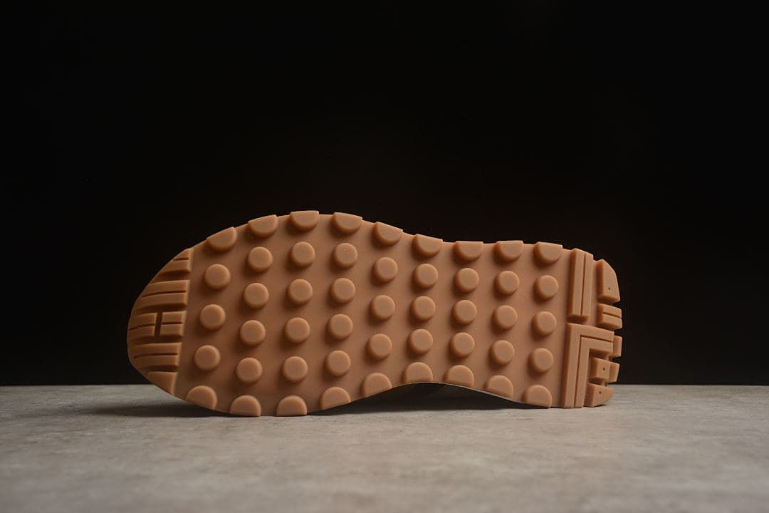 Underside of the sneaker showing the gum-colored tread pattern