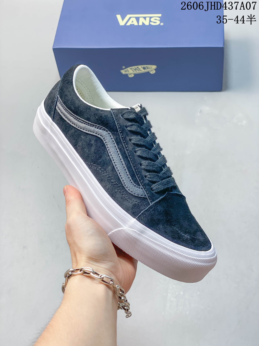 Side view of a dark navy Vans Old Skool 36 sneaker with a white side stripe and white outsole.