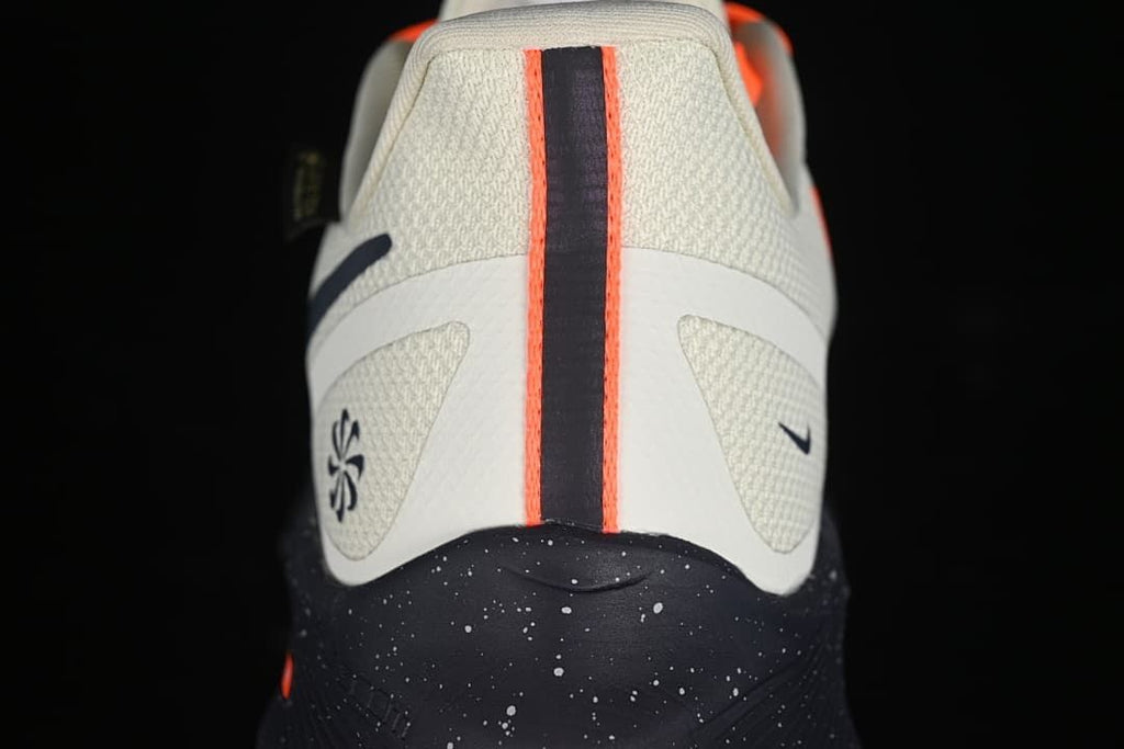 Rear view of the shoes showing navy and orange heel stripes and speckled midsoles