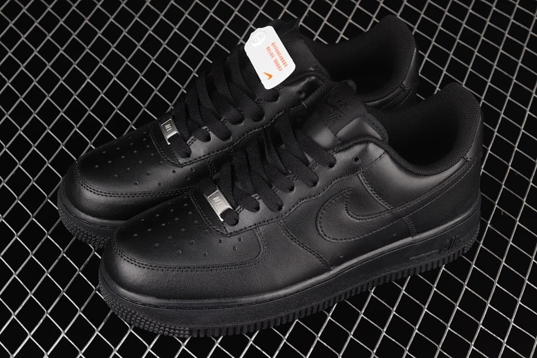 Pair of all-black low-top sneakers shown from above at an angle.