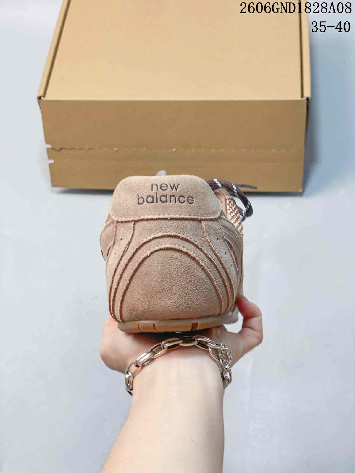 Rear view showing the sneaker heel and visible New Balance branding.