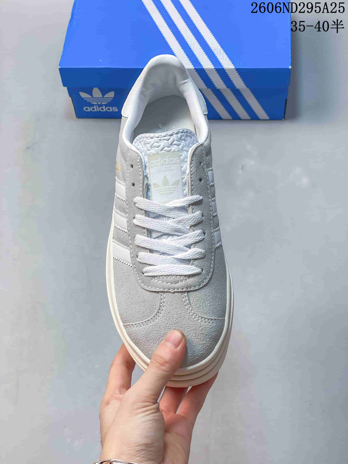 Top view of the sneaker showing its grey upper, white laces, and white stripes.