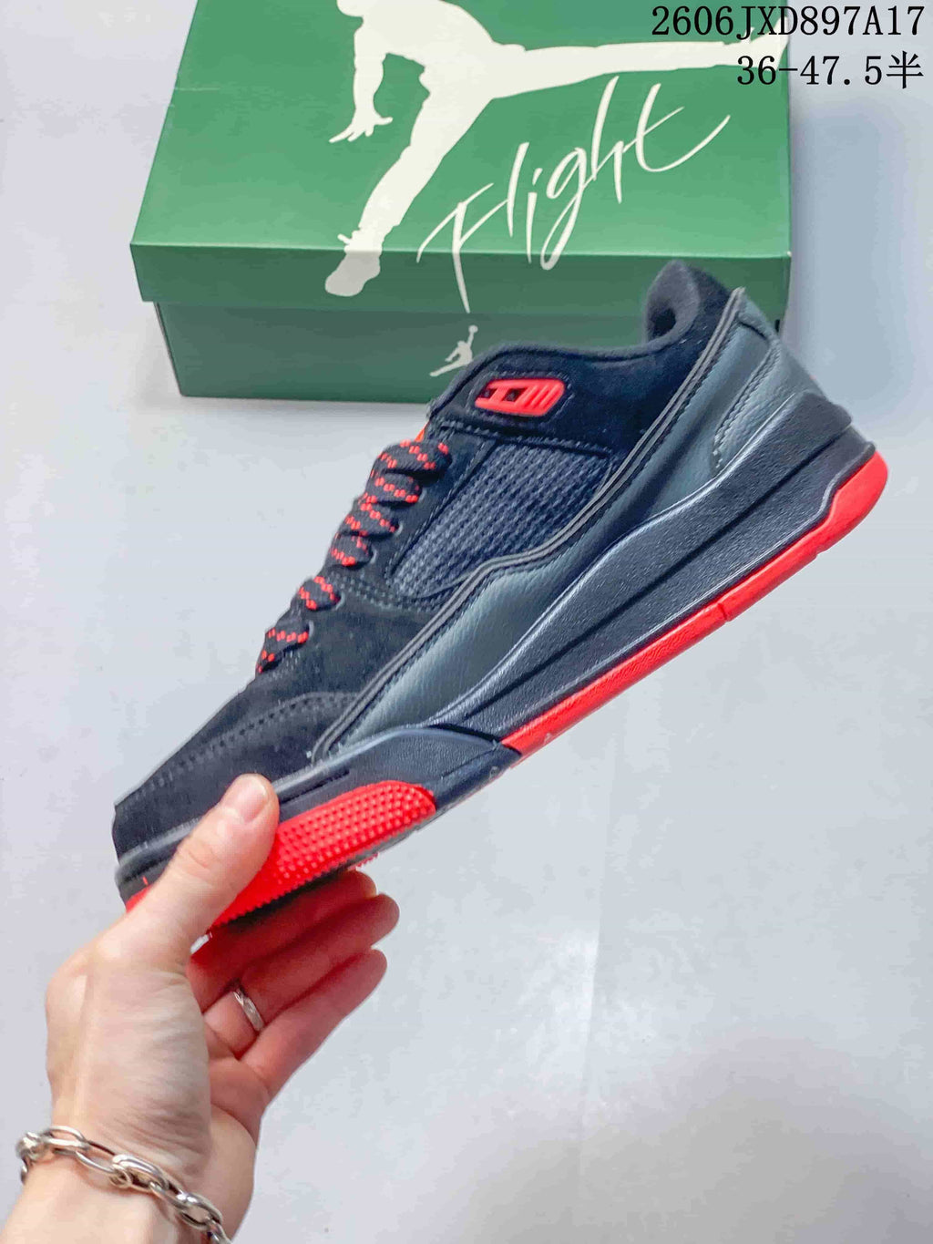Side profile showing the mesh panel and red outsole accents on a Jordan Flight Court shoe