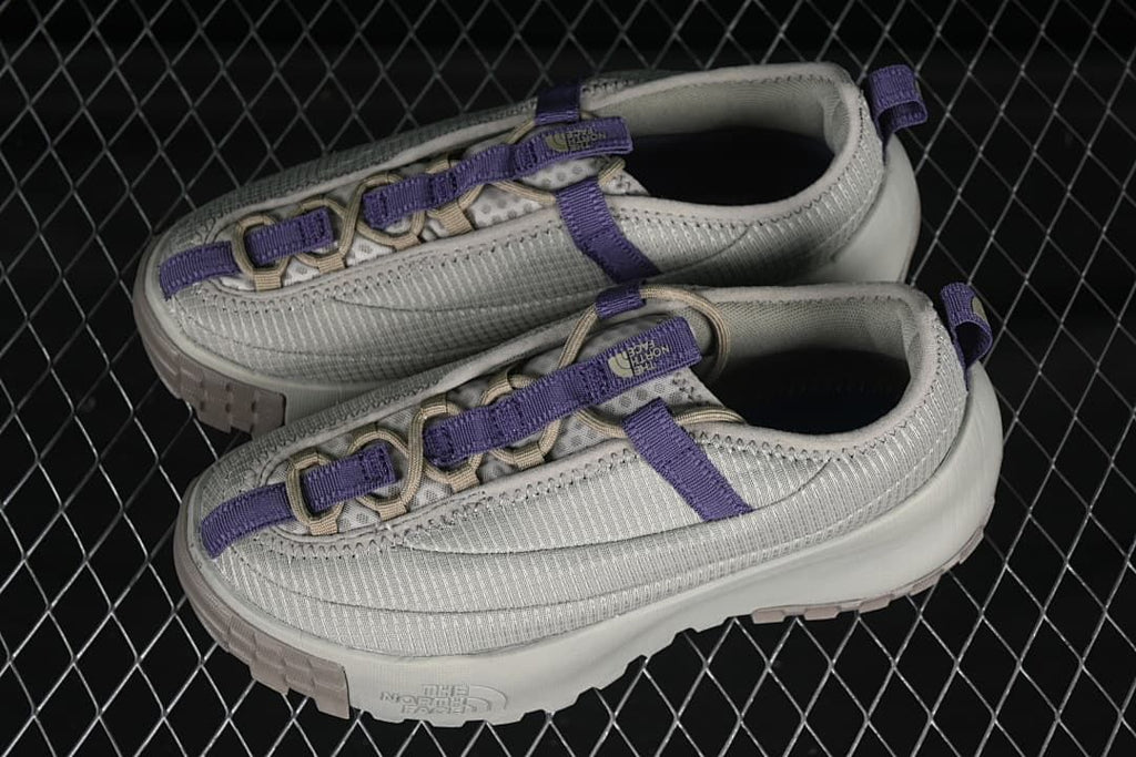Pair of clay grey low-top shoes with purple accents.