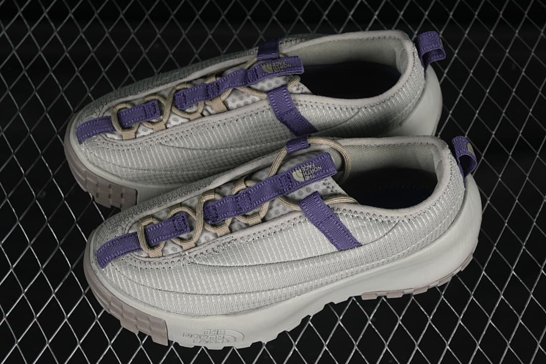 Pair of clay grey low-top shoes with purple accents.