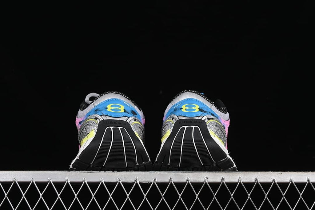 Rear view of both sneakers showing blue heel panels and black outsole sections