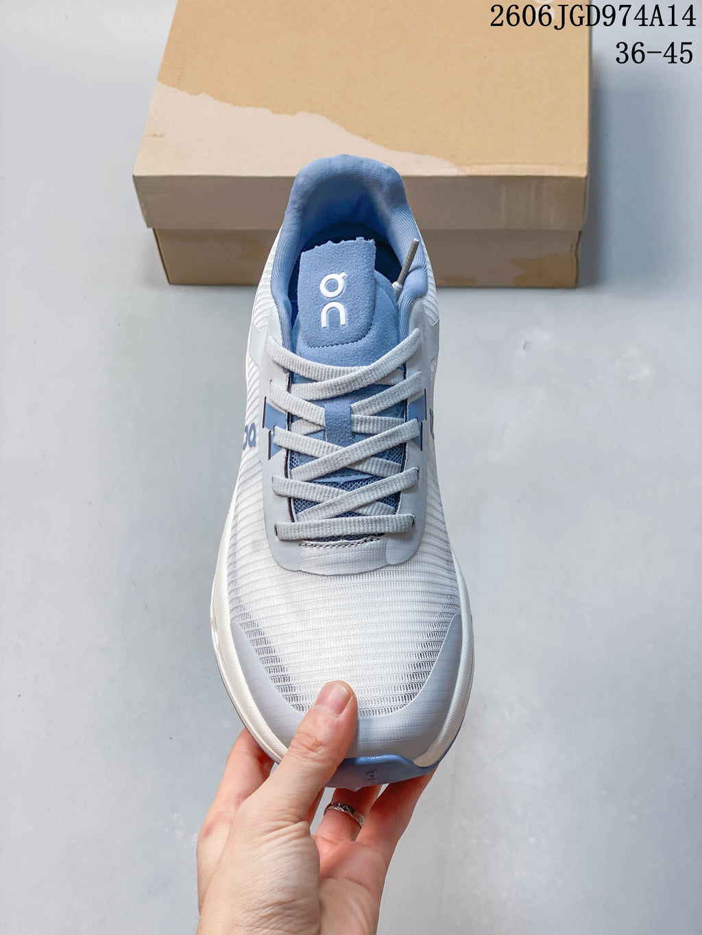 Top view of the laces and patterned upper on a white and blue On Cloudvista 2 shoe