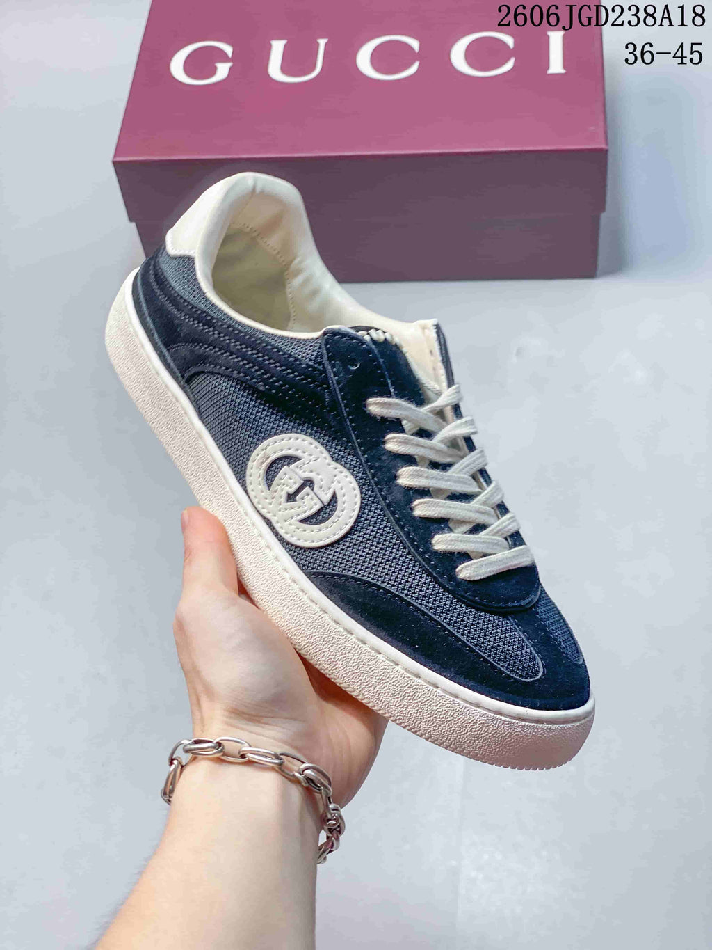 Angled side view of the navy and white low-top sneaker