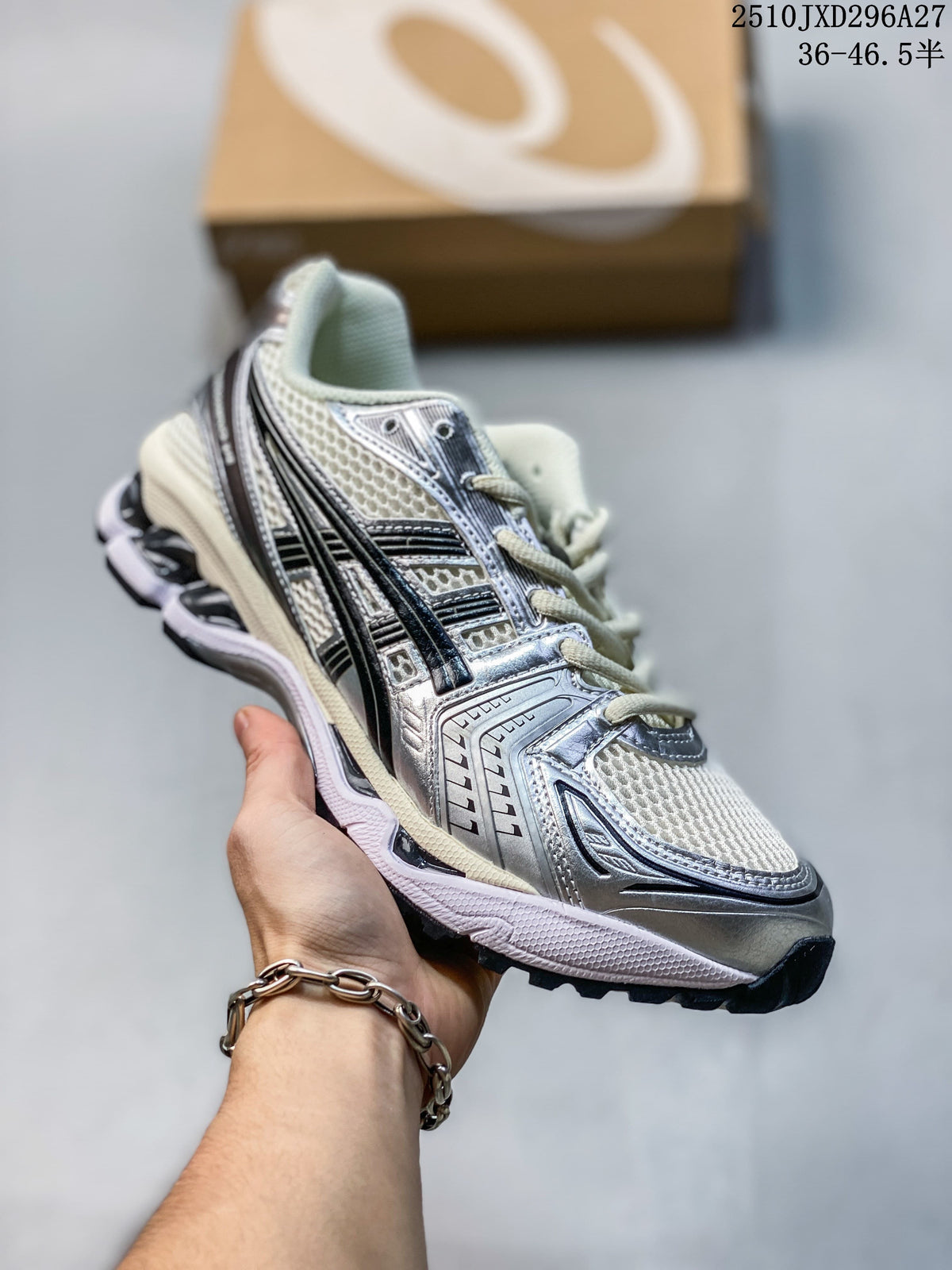 Silver and white mesh sneaker with black accents, held in hand.