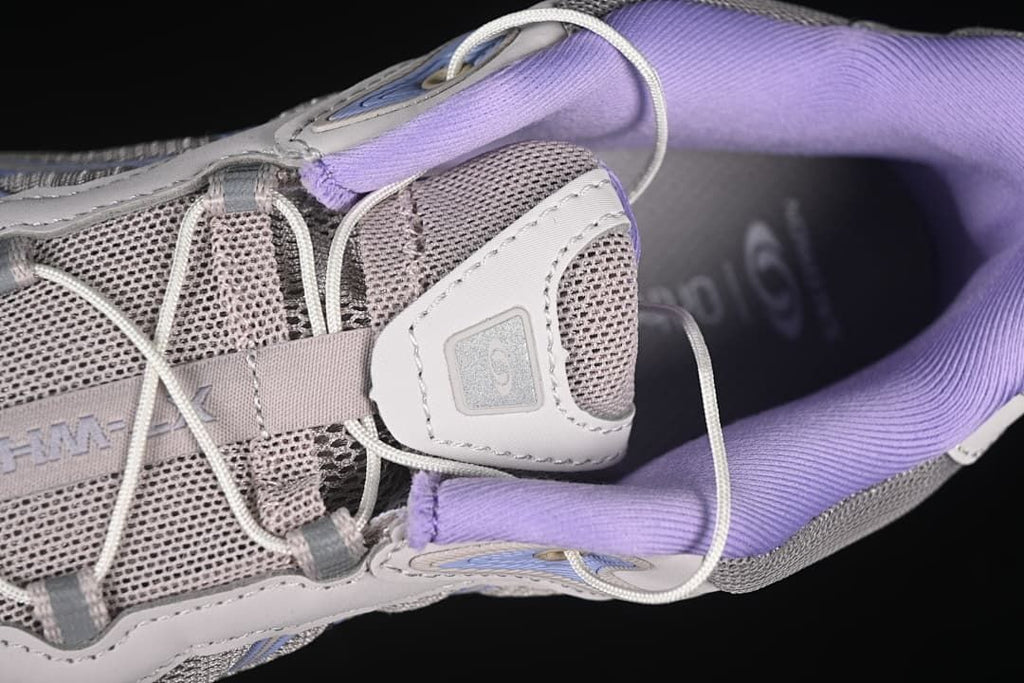 Top close-up of the cord lacing, mesh tongue, and padded lavender collar.