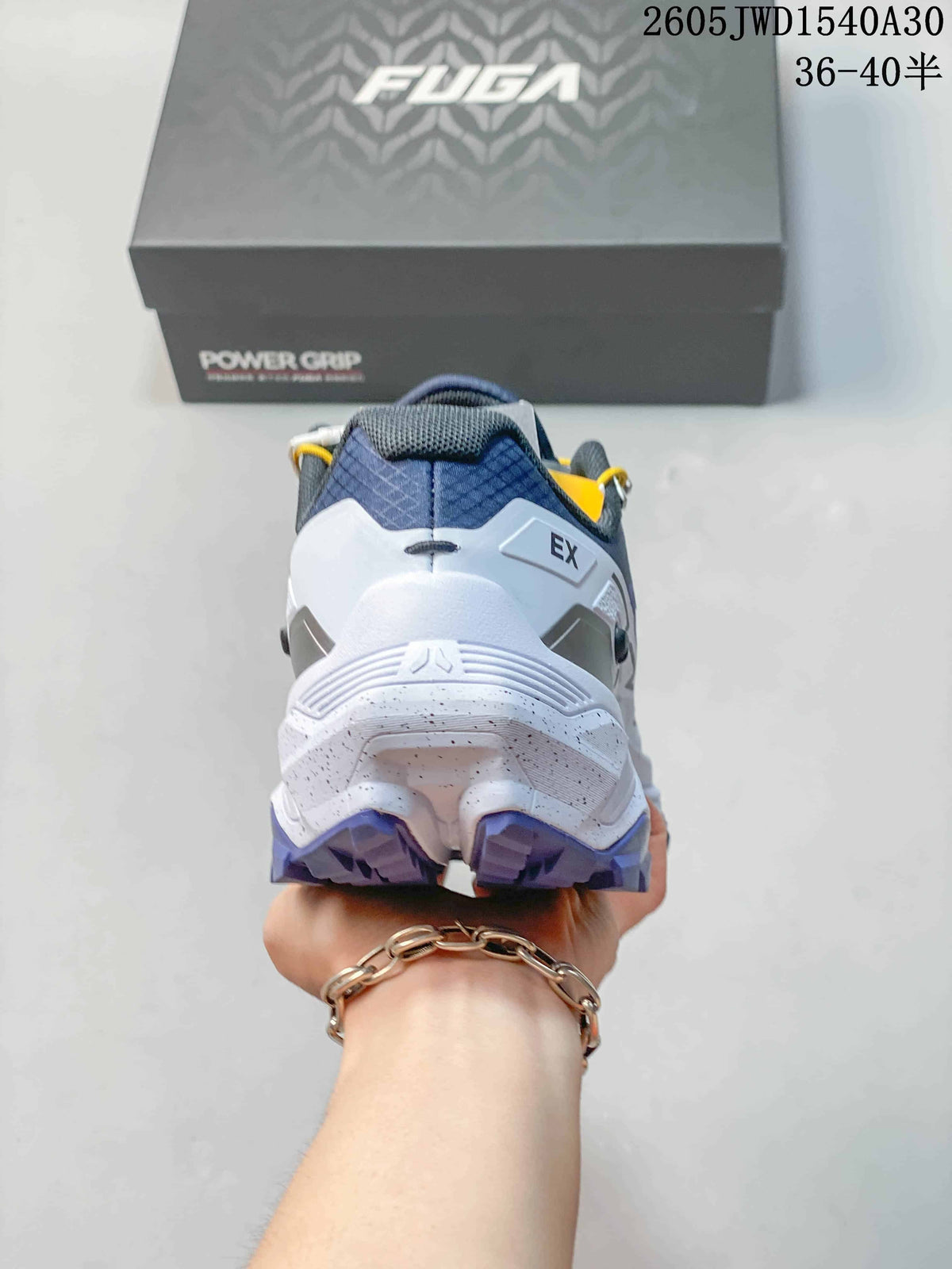 Rear view showing the white heel structure and purple outsole.