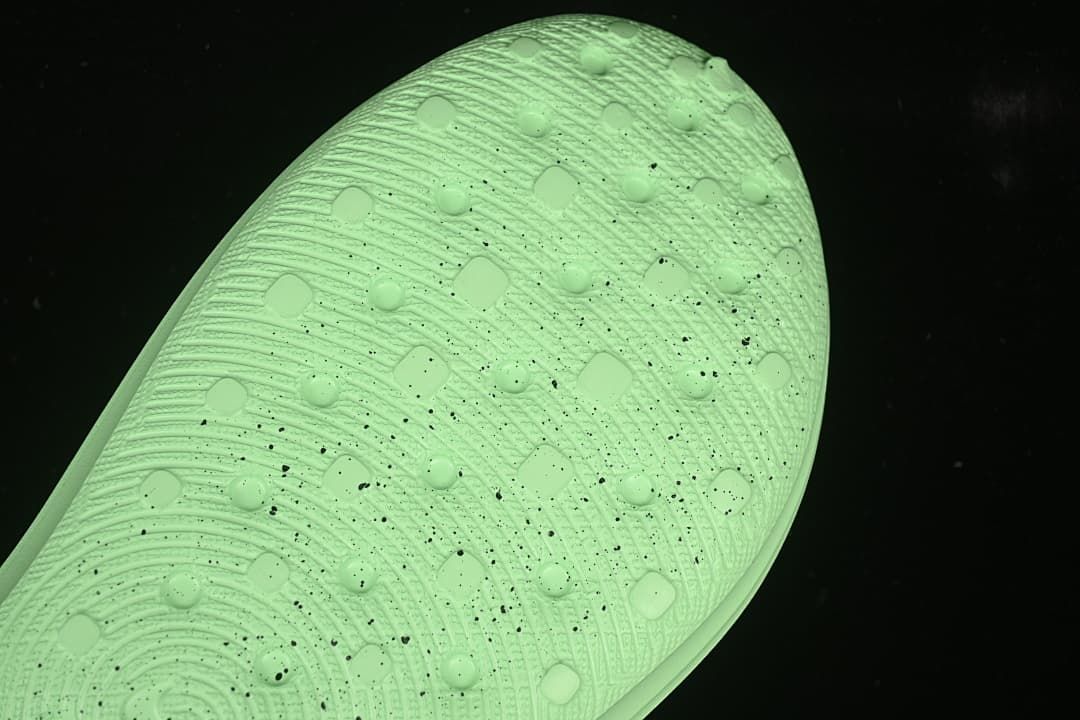 Close-up of the textured outsole on a light green clog