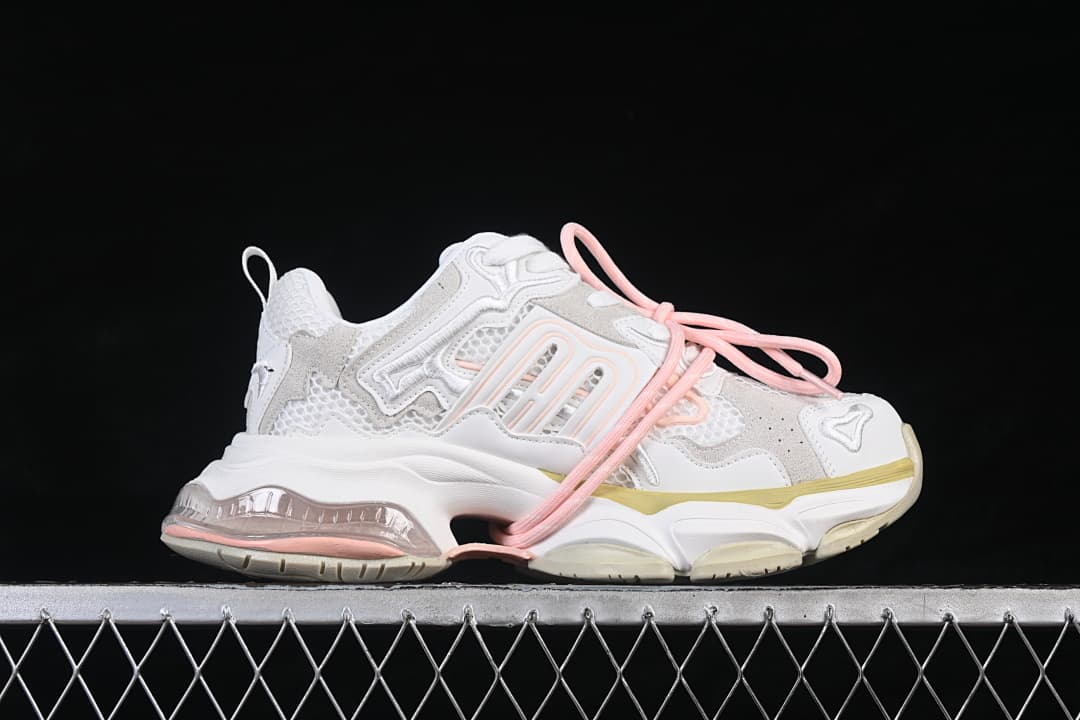 Side view of a GG-CC sneaker with mesh panels, pink laces, pale yellow accents, and a chunky sole.
