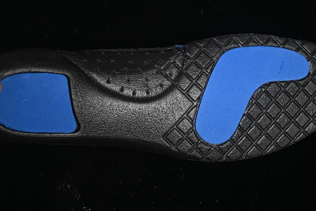 Close-up of the black outsole with blue traction sections.