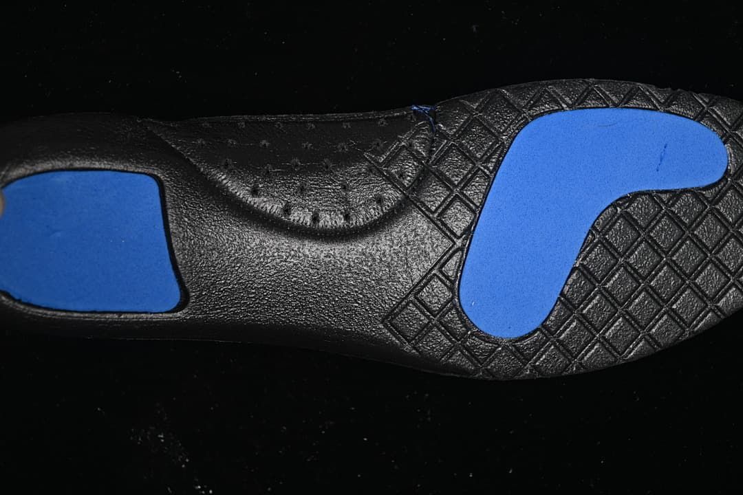 Close-up of the black outsole with blue traction sections.