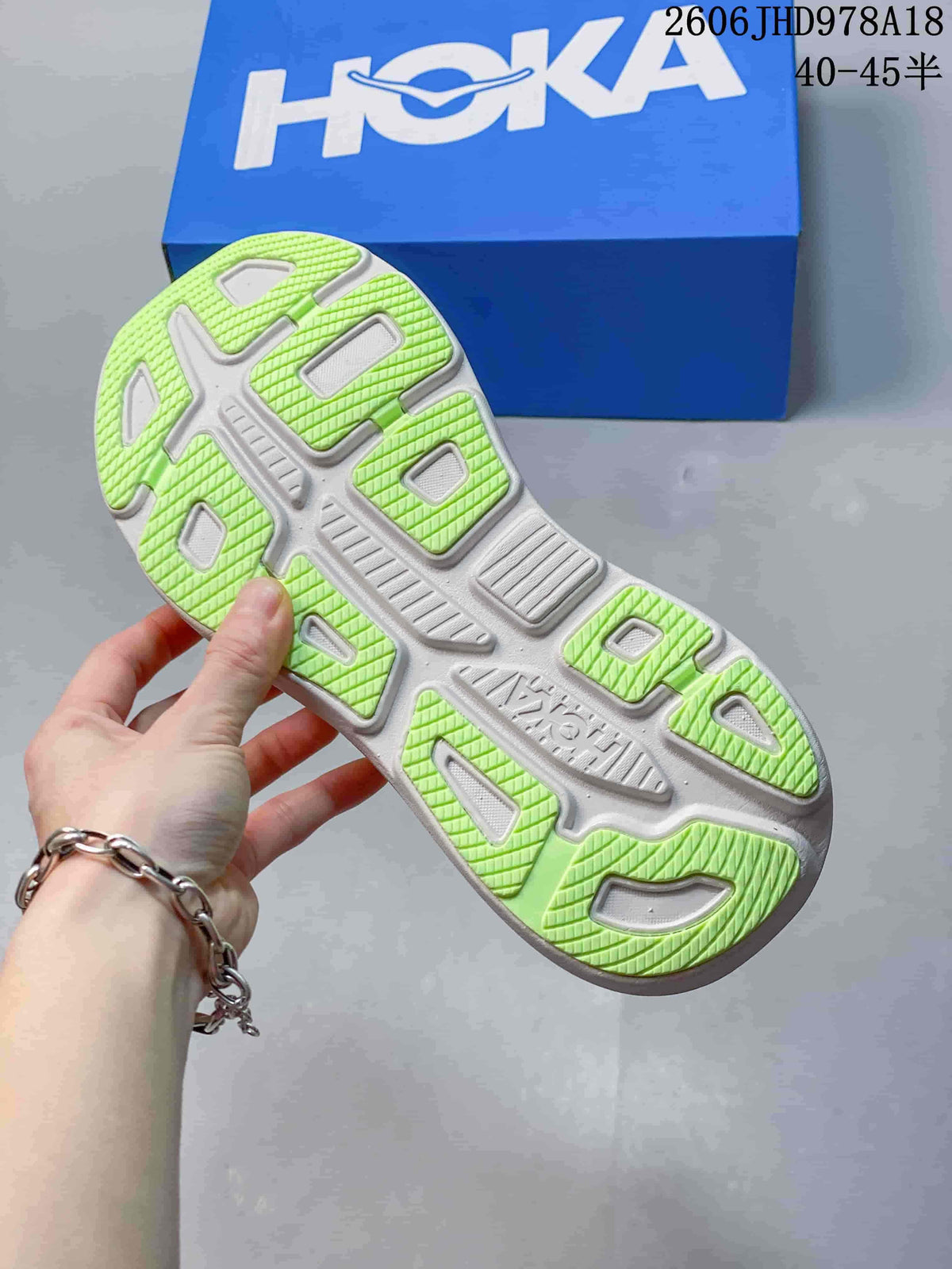 Close-up of the Bondi 9 outsole showing lime-green tread sections and white structural details