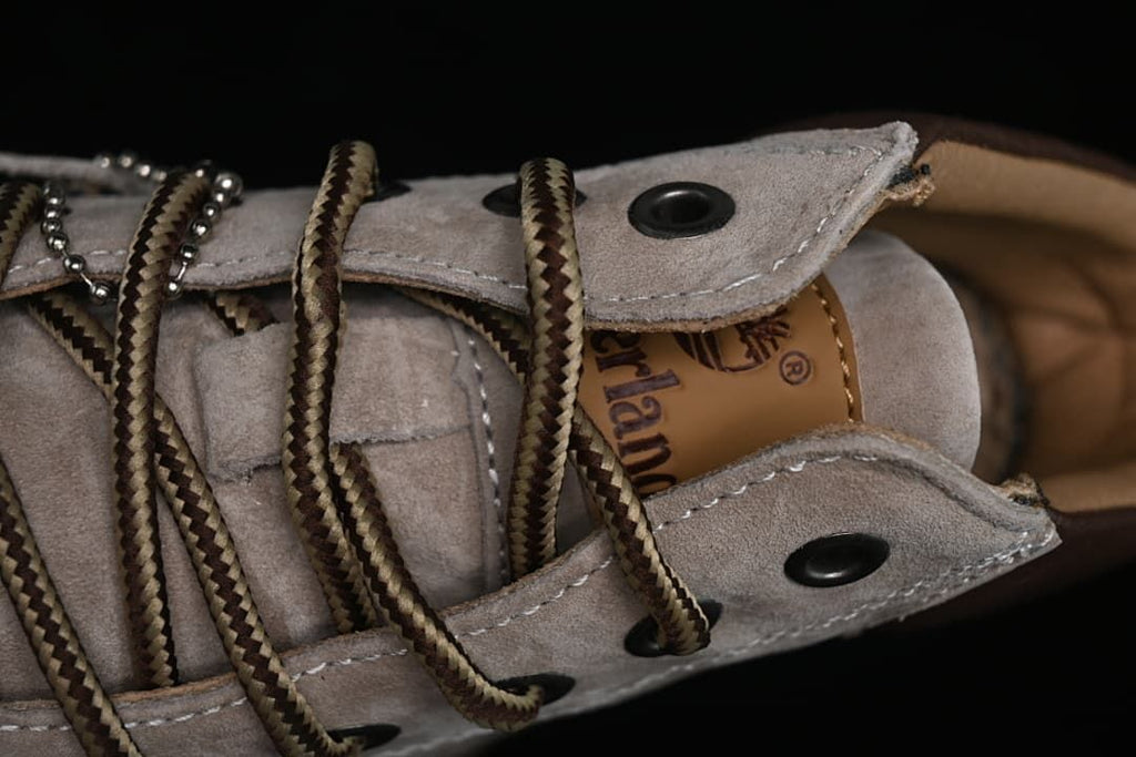 Close-up of the lace-up eyelets, tongue, and brown-and-tan laces