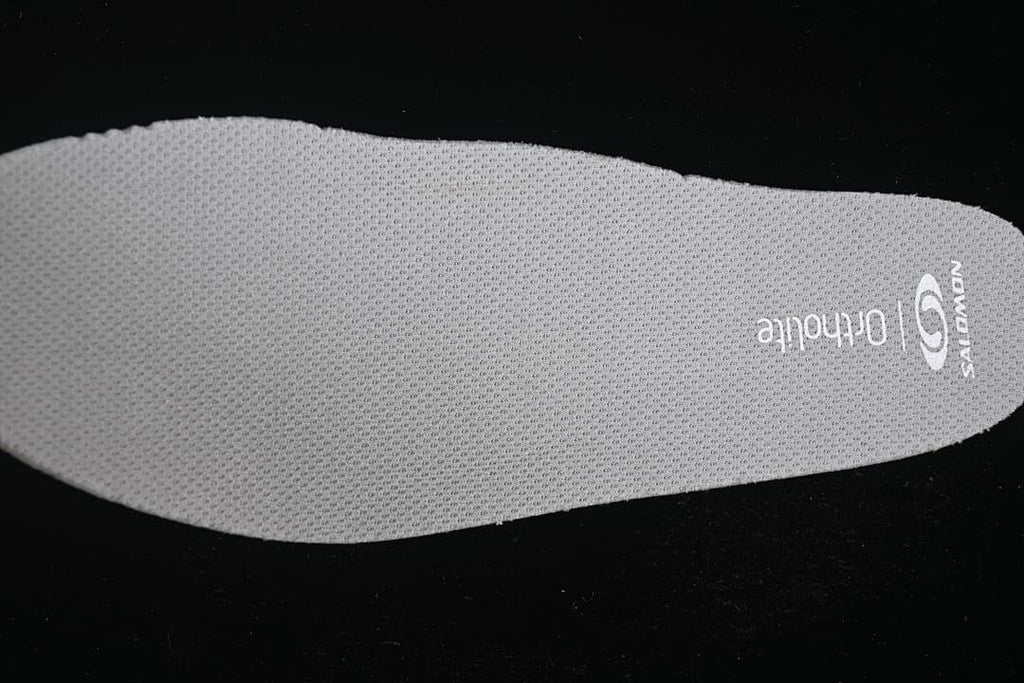 Grey shoe insole with visible Salomon branding