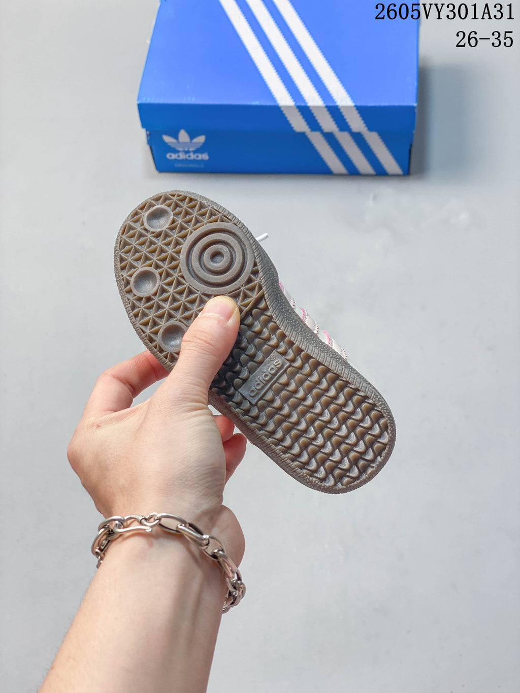 Close-up of the patterned brown outsole of a kids' Samba Jane shoe.