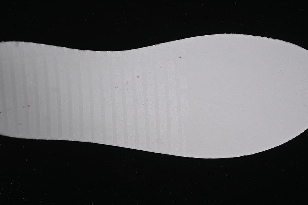 White shoe insole shown against a dark background