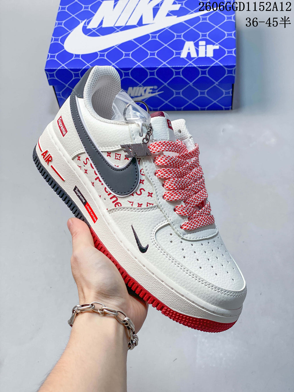Angled side view of the sneaker with red accents and a gray swoosh