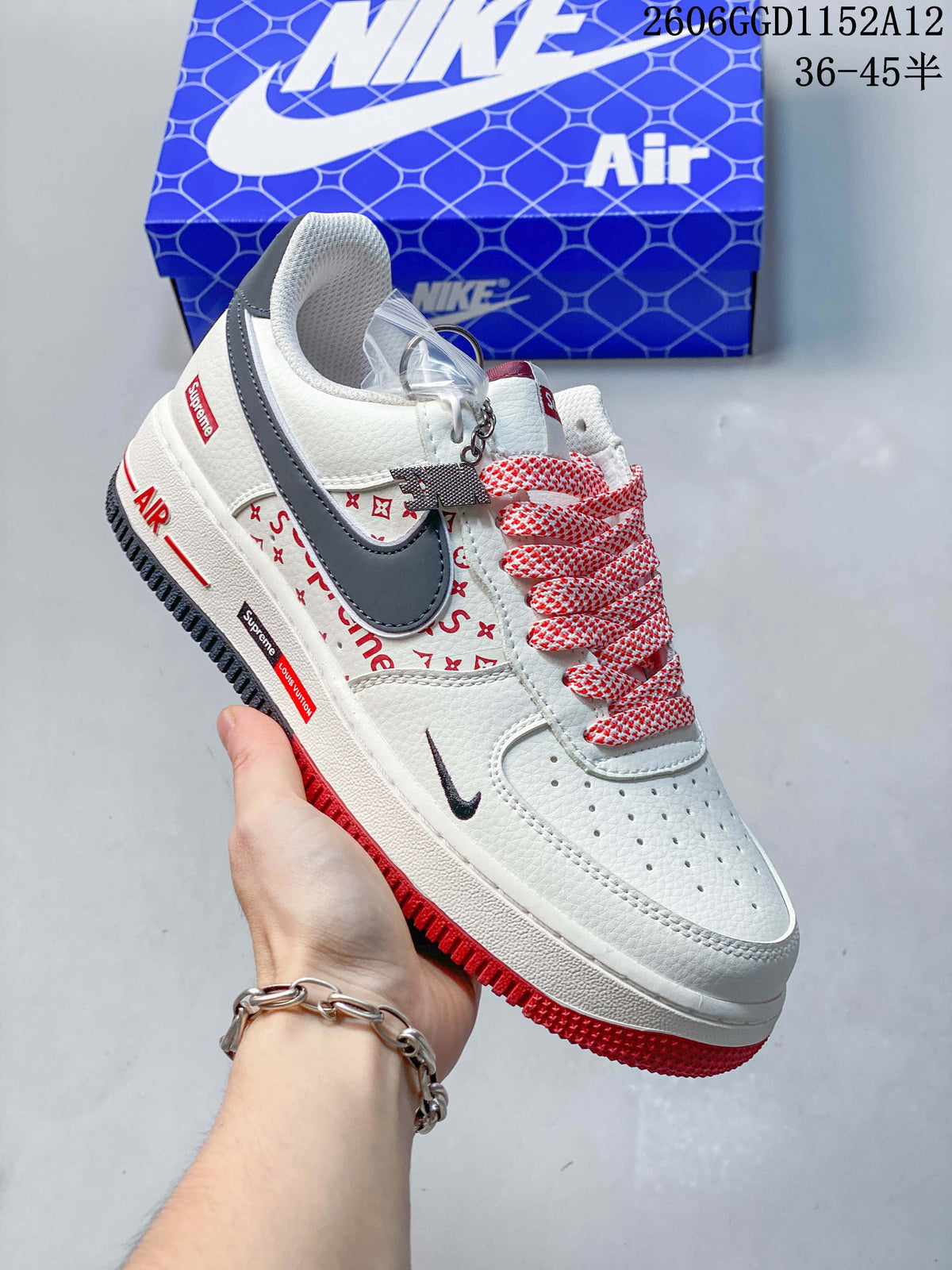 Angled side view of the sneaker with red accents and a gray swoosh