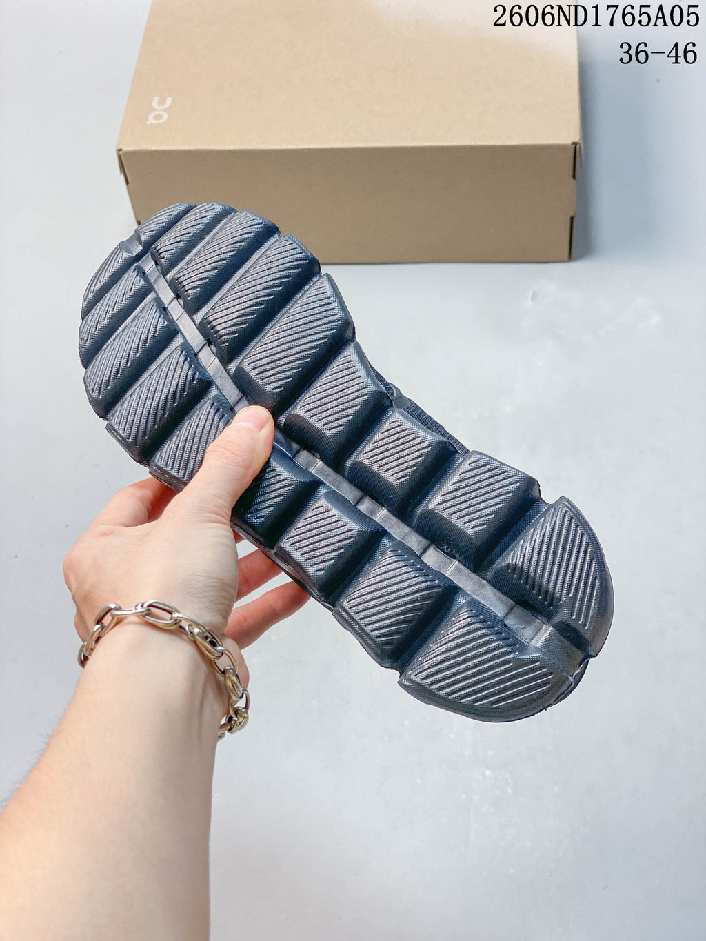 Close-up of the segmented outsole on a dark gray sneaker.