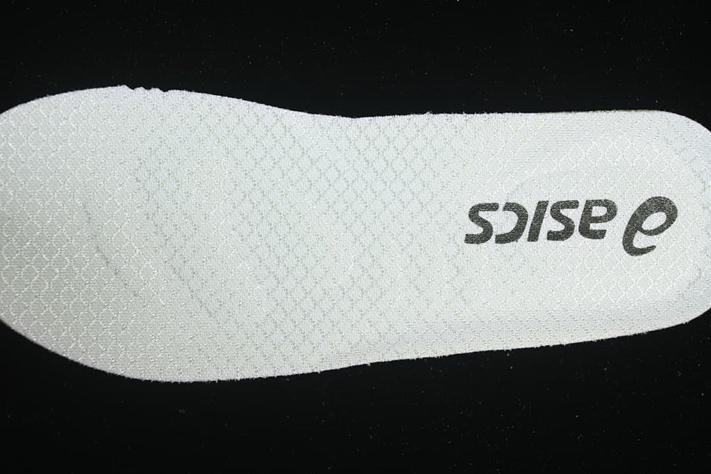 Close-up of a light-colored insole with ASICS branding.