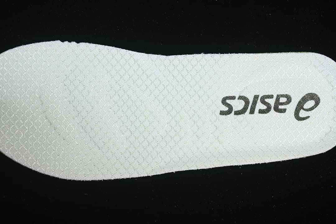 Close-up of a light-colored insole with ASICS branding.