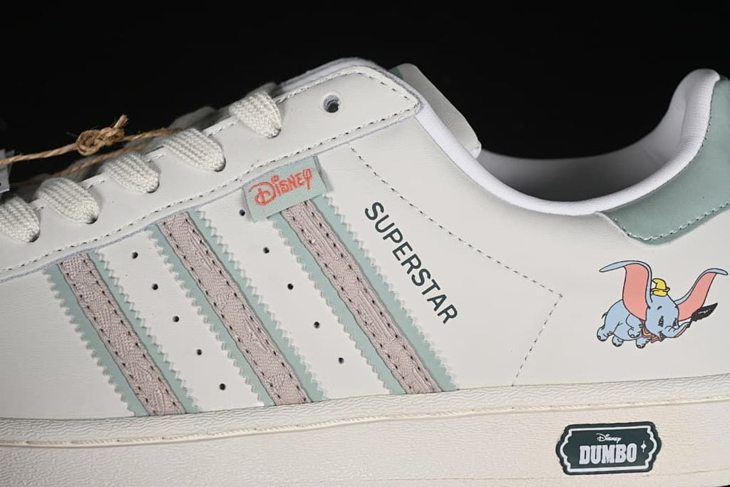 Side detail showing three stripes, Dumbo artwork, and shell toe