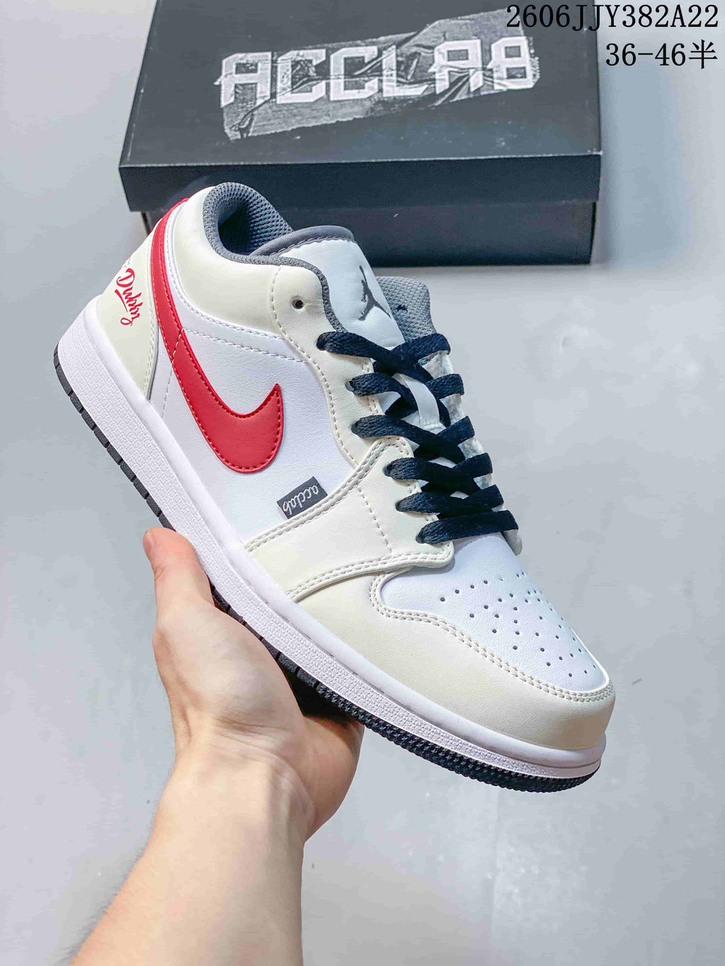 Angled side view of a white low-top sneaker with red side accent and dark laces