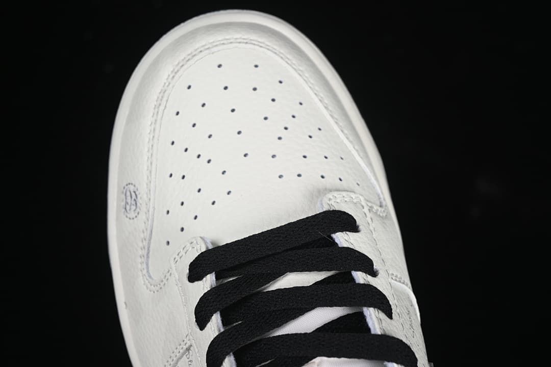 Top-down close-up of the perforated toe and black laces.