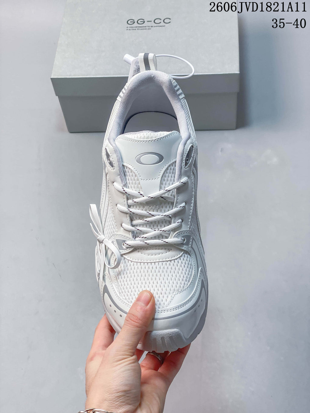 Top view of the white lace-up sneaker and bow detail