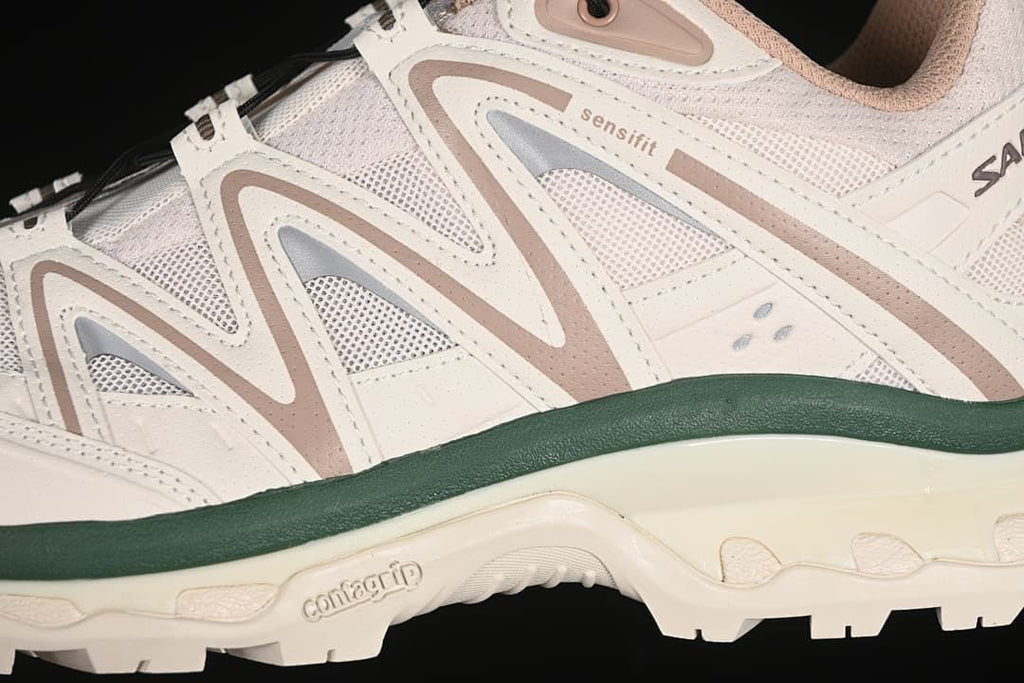 Close-up of layered side panels and the dark green midsole accent.
