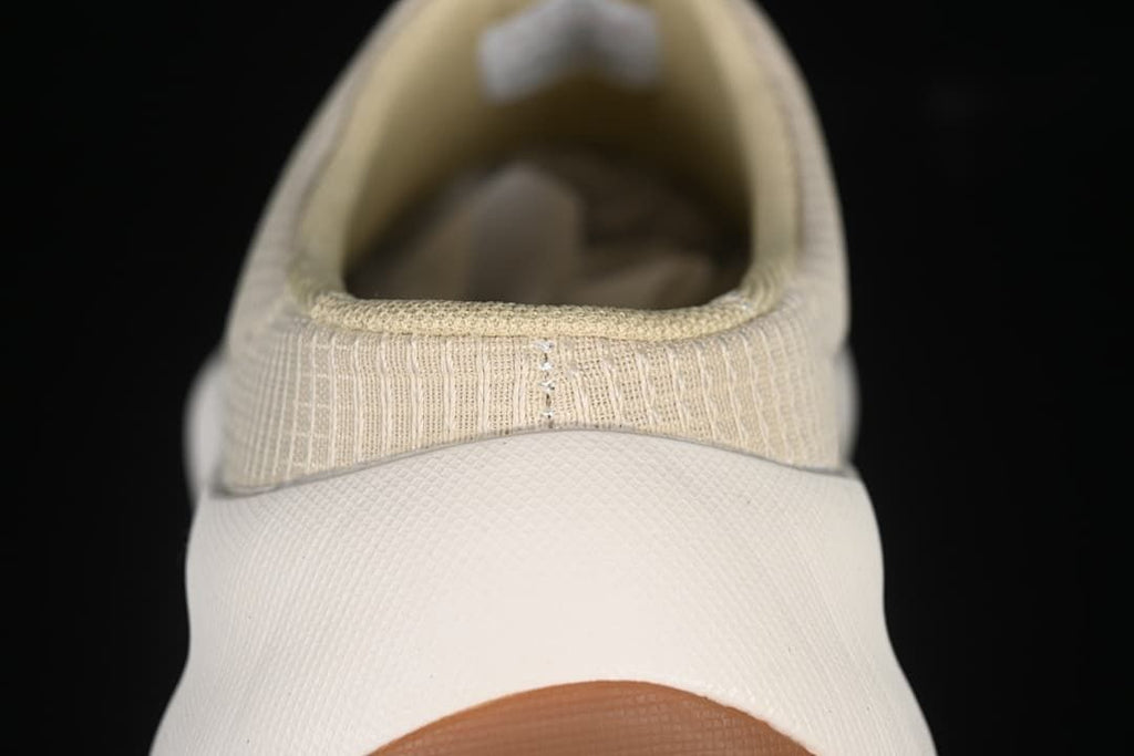 Rear view of the mule sneaker showing the heel opening and pull loop.