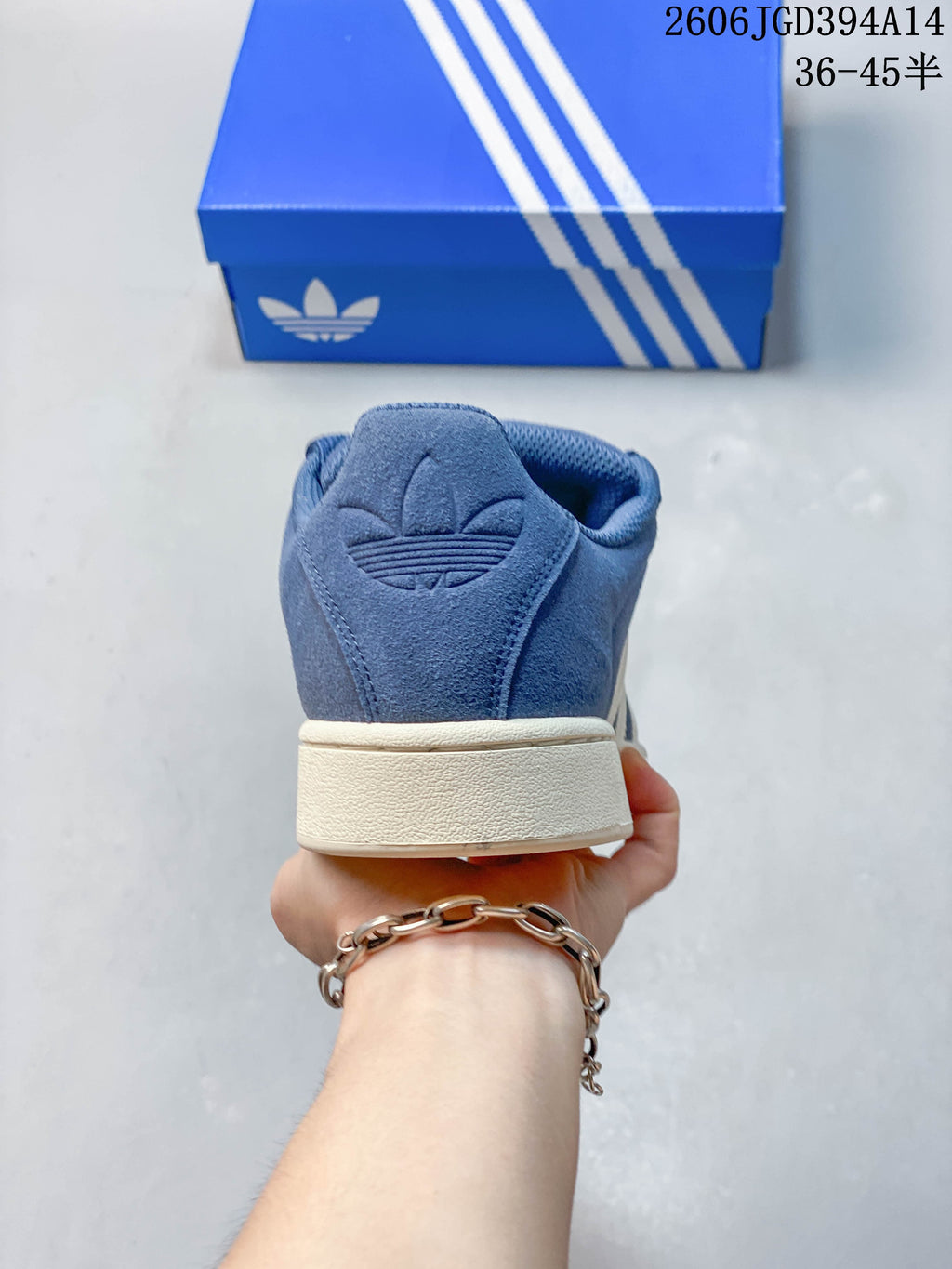 Rear view of the blue low-top sneaker with an off-white heel sole