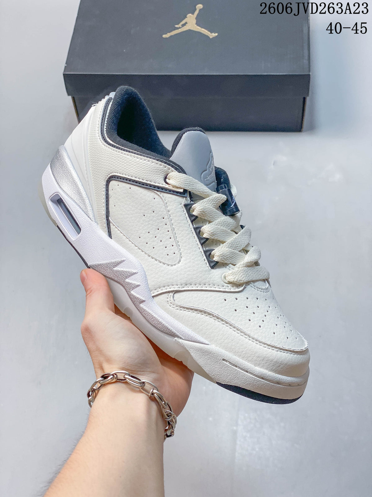 Side view of a white and light gray Jordan Sixty Plus Low sneaker.