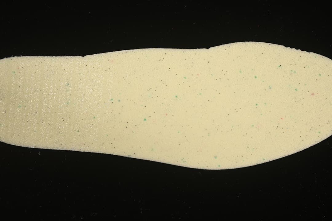 Light-colored shoe insole shown separately