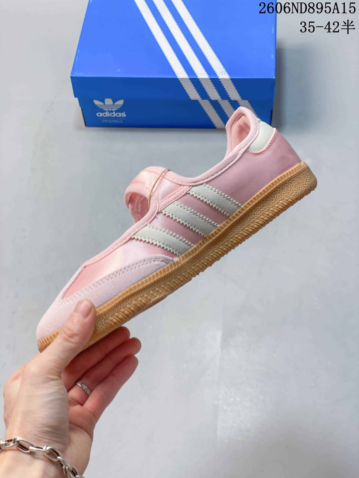 Side profile showing pink upper, pale stripes, strap and gum outsole