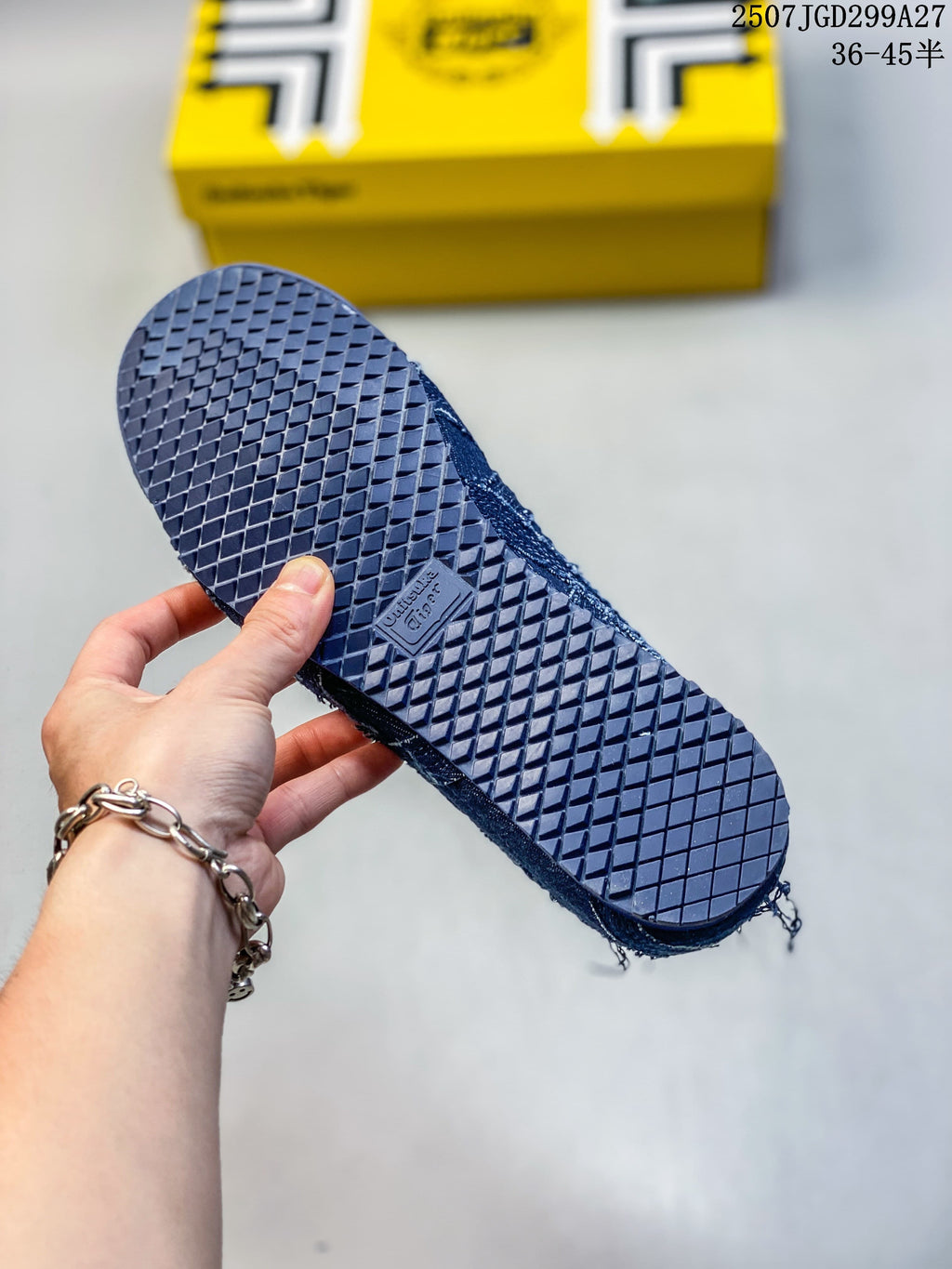 Close-up of the textured outsole on a dark blue sneaker