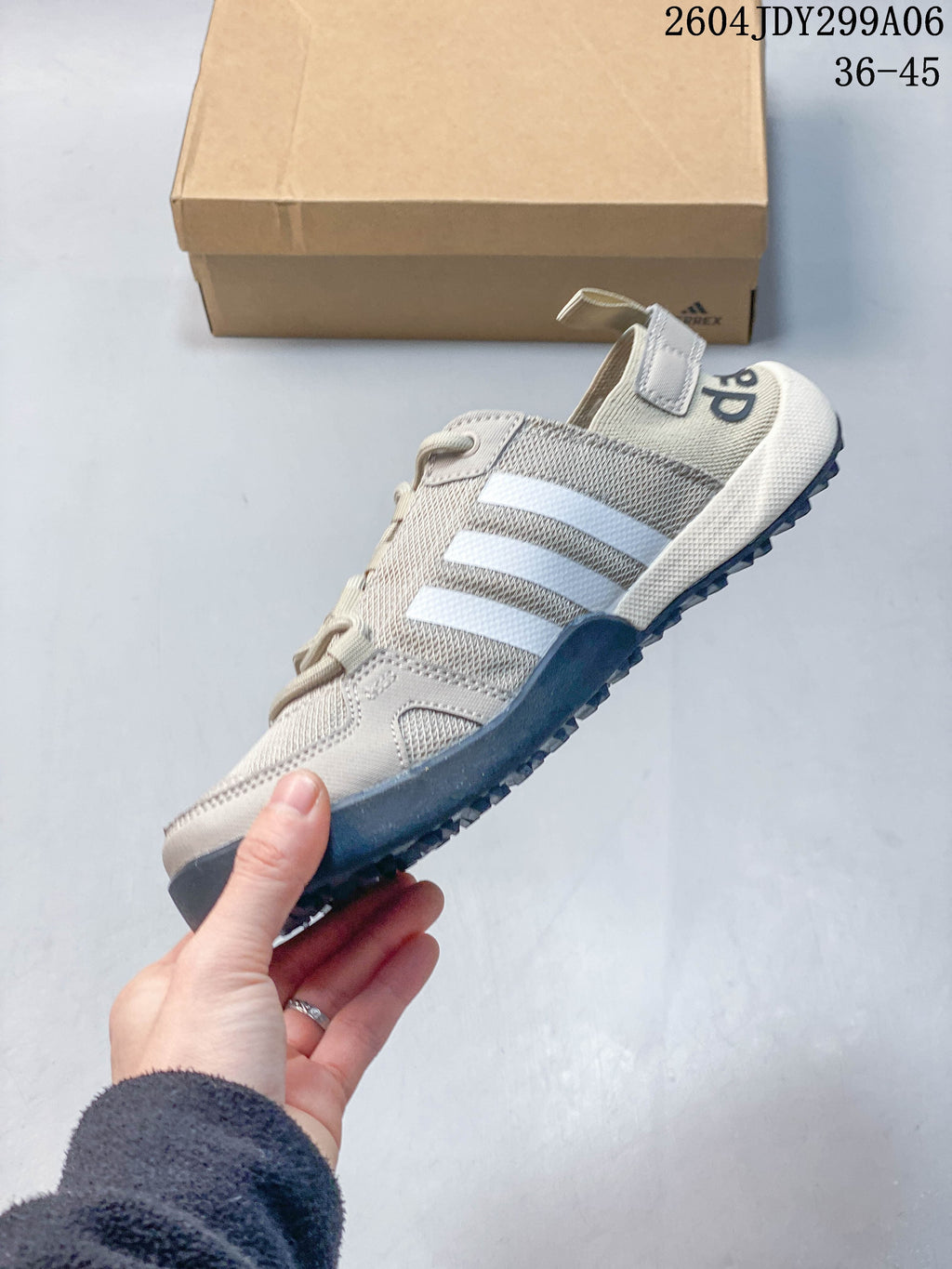 Side view of a light beige Adidas Terrex lace-up shoe with white stripes and a dark outsole; image overlay reads 36–45.