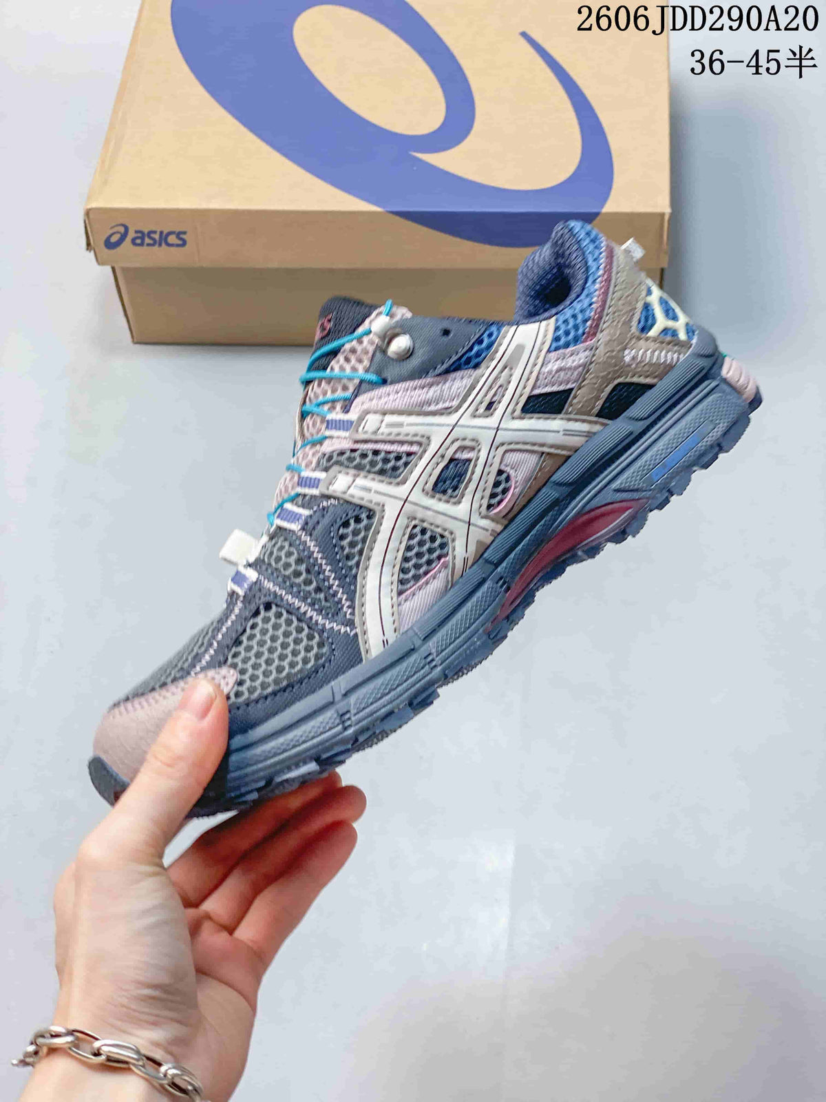 Side view of a gray and pink ASICS Gel-Kahana 8 shoe with mesh panels and turquoise laces.