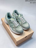 Pair of sage-green ASICS GEL-1130 sneakers displayed on a shoebox