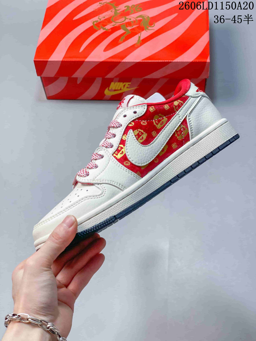 Side view of the sneaker with a white overlay and red patterned panel