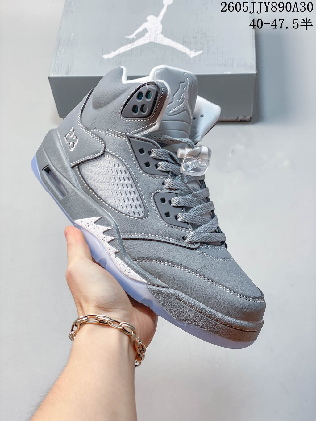 Angled side view of a grey Jordan Air Jordan 5 Retro high-top sneaker