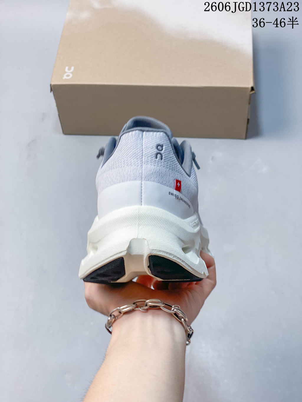 Rear view of a gray and white sneaker with a sculpted sole