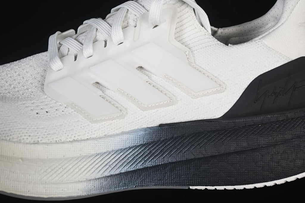 Close-up of the white knit-look upper, lace support and black midsole