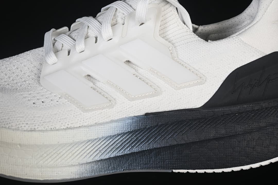 Close-up of the white knit-look upper, lace support and black midsole