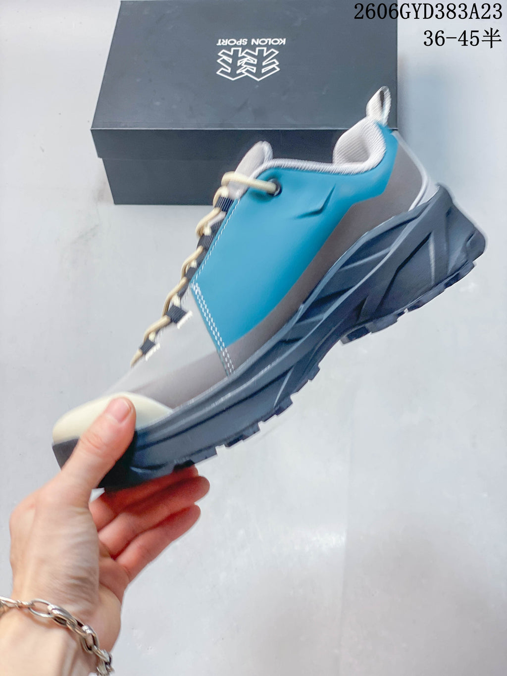 Side view of the gray and turquoise low-top outdoor shoe