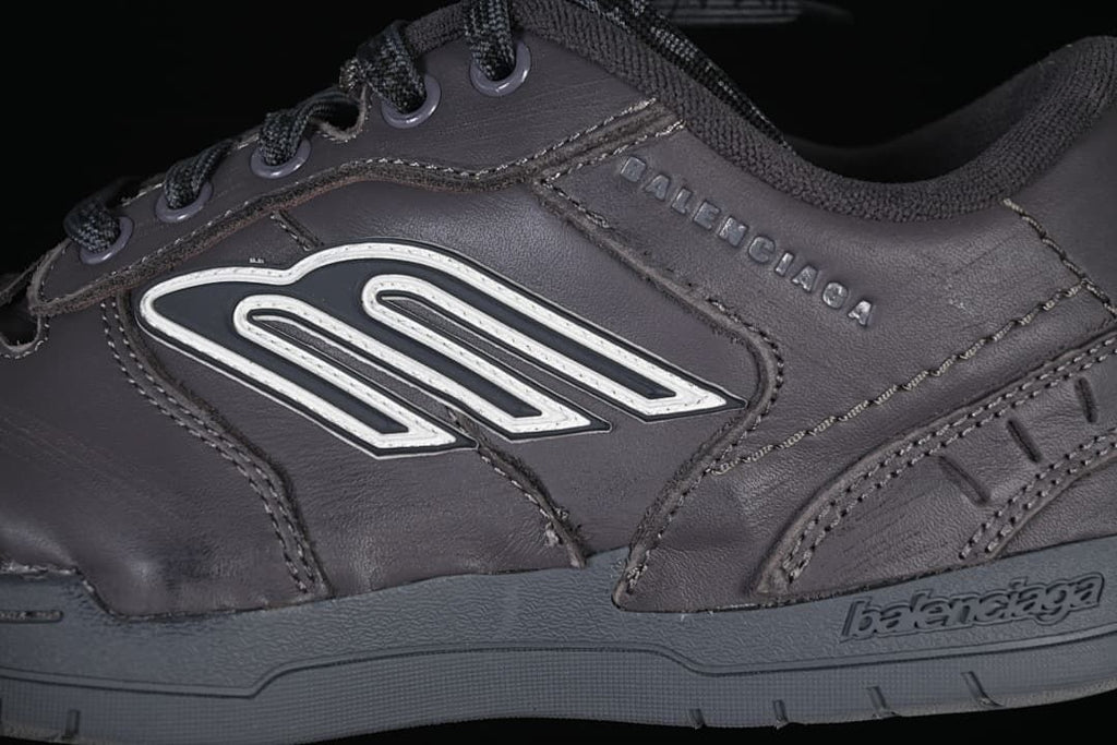 Close-up of side emblem, layered panels and outsole branding
